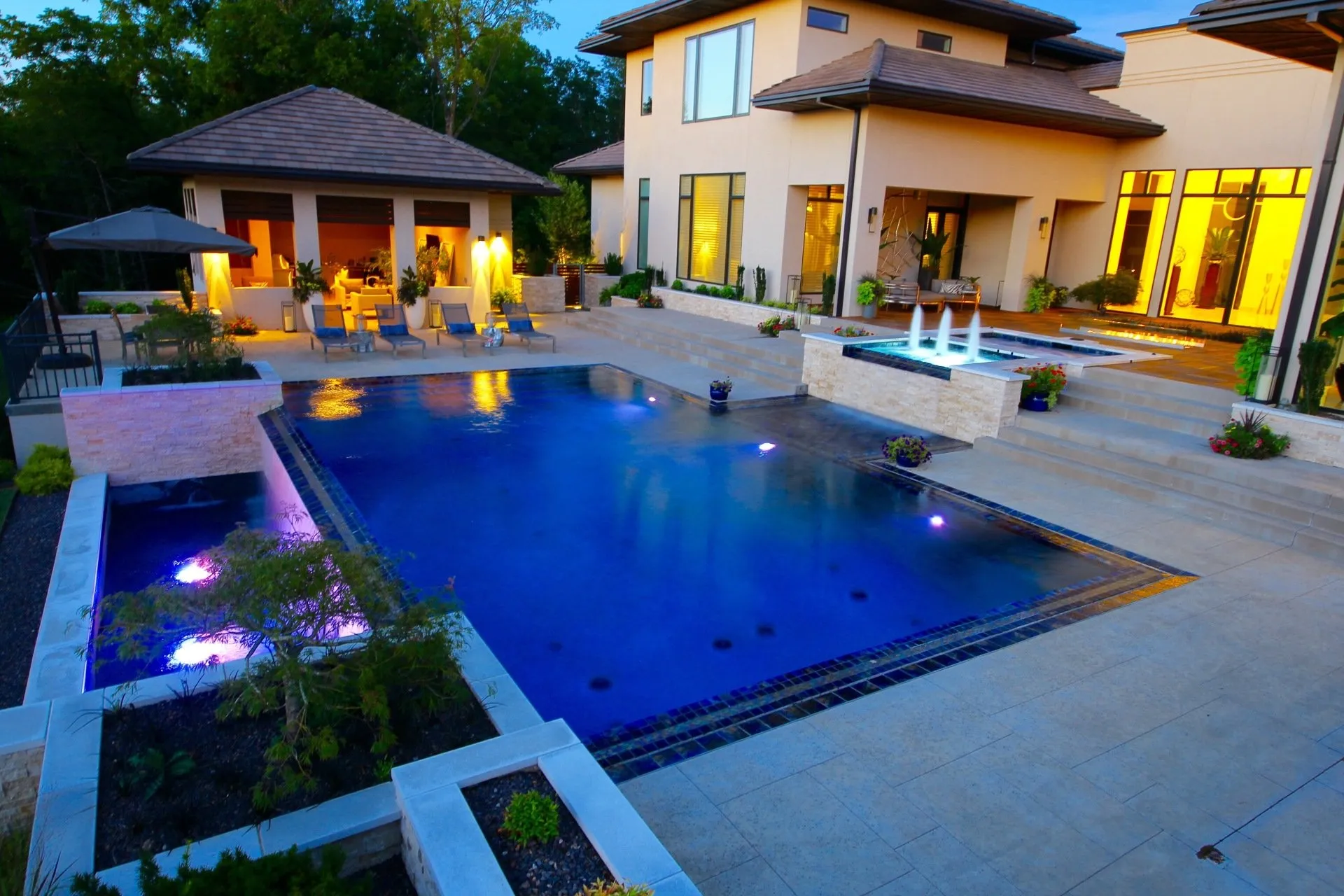 Luxury backyard pool at dusk